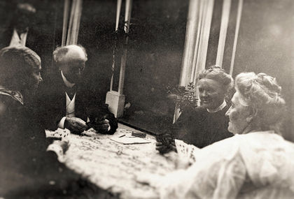 Lord and Lady Aberdeen and Mr. and Mrs. Laurier seated at a table playing cards.